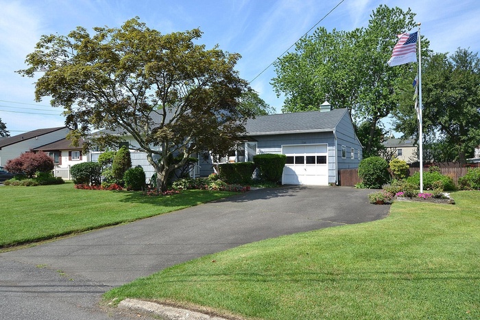 Front of house featuring a garage, asphalt driveway