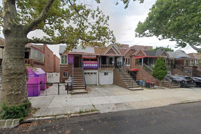 View of front of property with stairs, a garage, and driveway