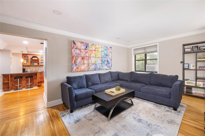 Over-sized Living room with beautiful hardwood floors and open access to kitchen and dinning area.