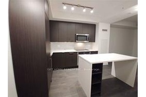 This bright and open concept unit features a modern kitchen with a large island, perfect for entertaining.