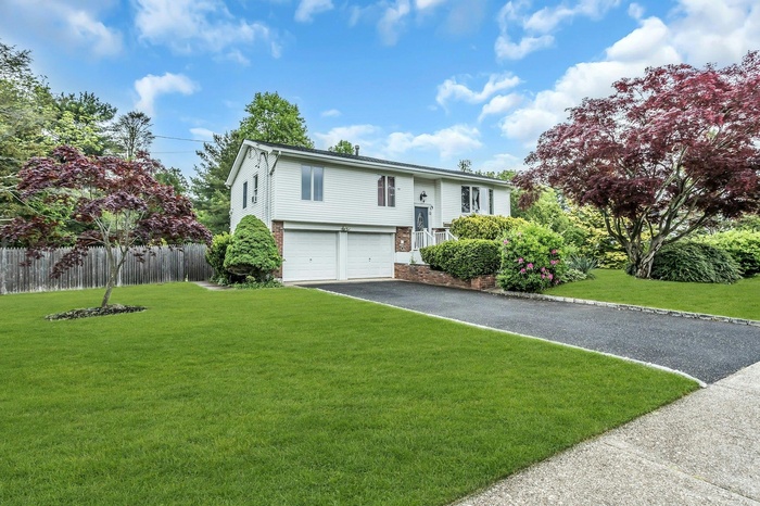 Hi Ranch with an attached garage and driveway