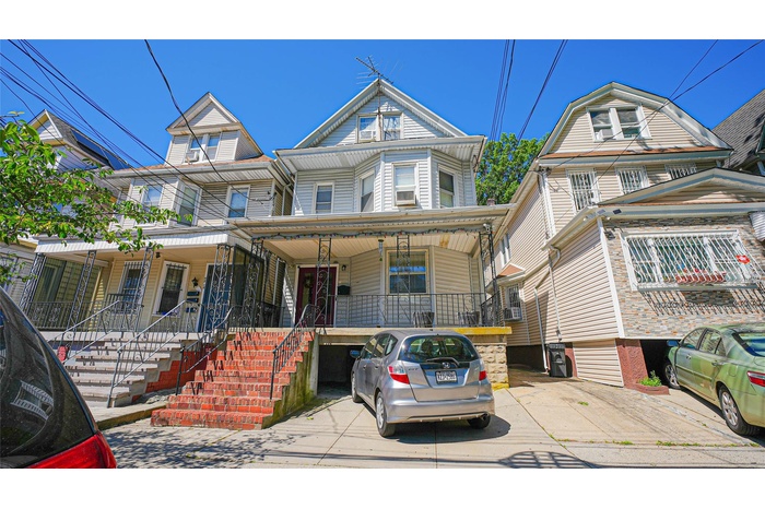 Townhome / multi-family property with a porch and stairs