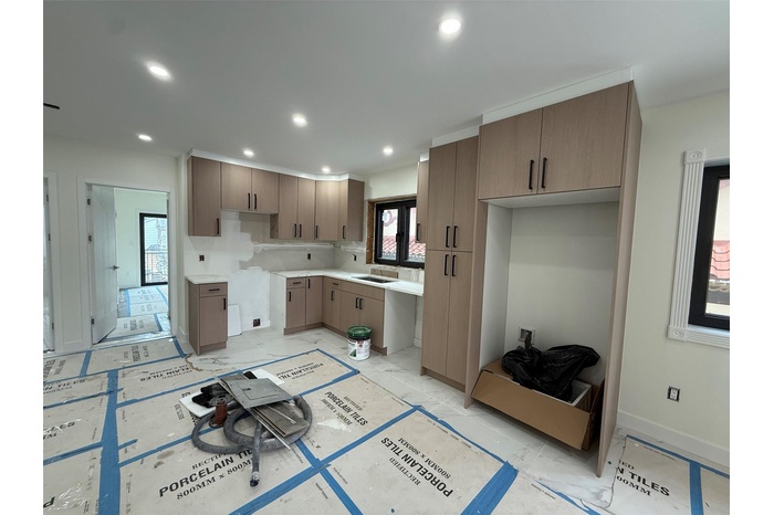 Kitchen with light marble finish floors, recessed lighting, and light countertops