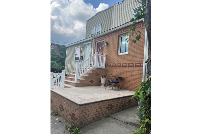 Back of house featuring brick siding