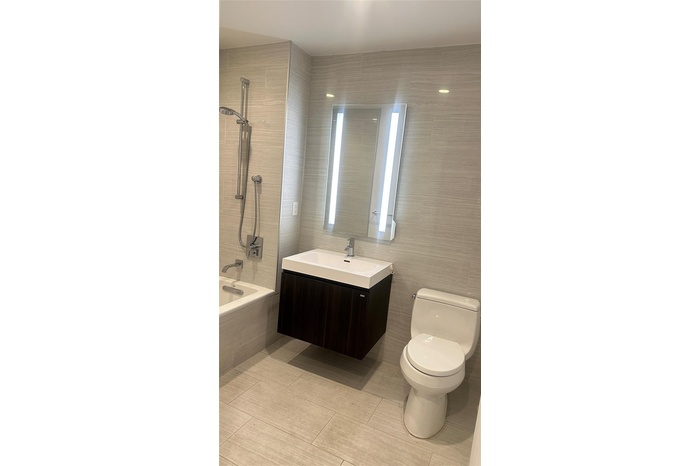 Full bathroom with vanity, tile walls, tiled shower / bath, and tile patterned flooring