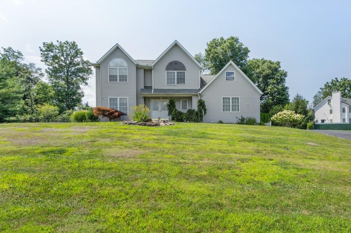 Traditional-style house with a front lawn
