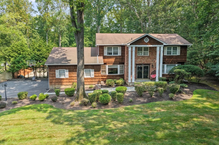 Greek revival inspired property with a front lawn