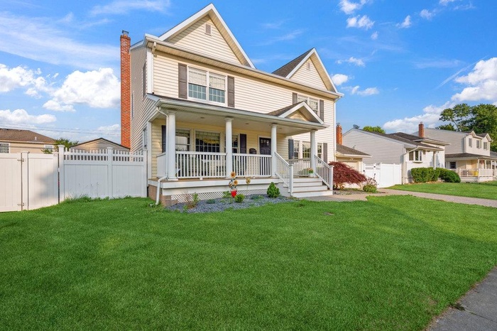 View of front of home featuring covered porch and a chimney