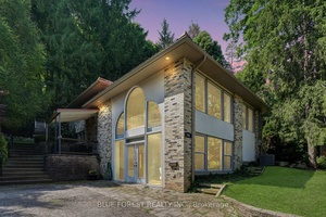 Situated directly across from the iconic Springbank Park, this hillside home offers an unmatched connection to nature in the heart of the city.