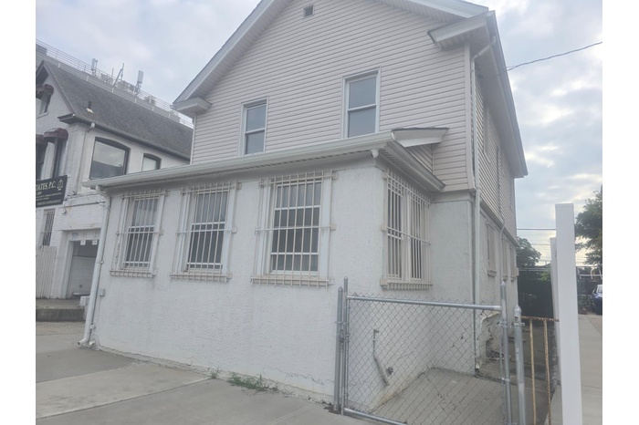 View of side of property featuring a gate