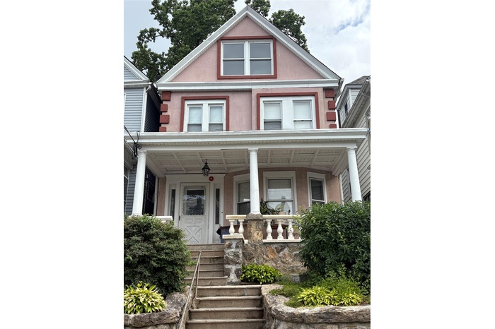 house with stucco siding and a porch