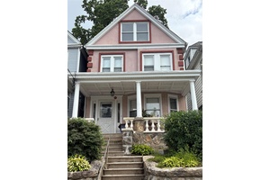 This single family residence in East Yonkers features beautiful stucco on the exterior.