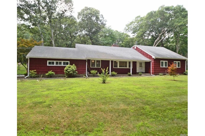 Single story home featuring a front yard and a chimney