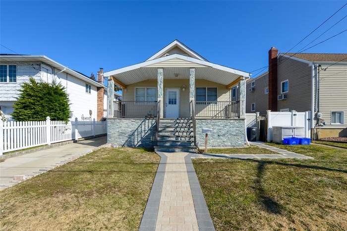 View of front of house with a porch and stairway