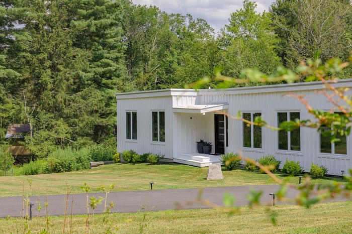 Rear view of house featuring a yard