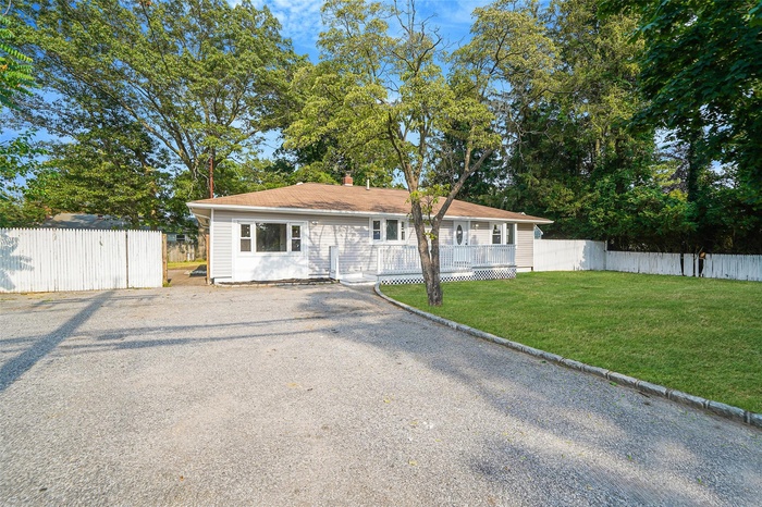 View of front of property featuring driveway and a chimney