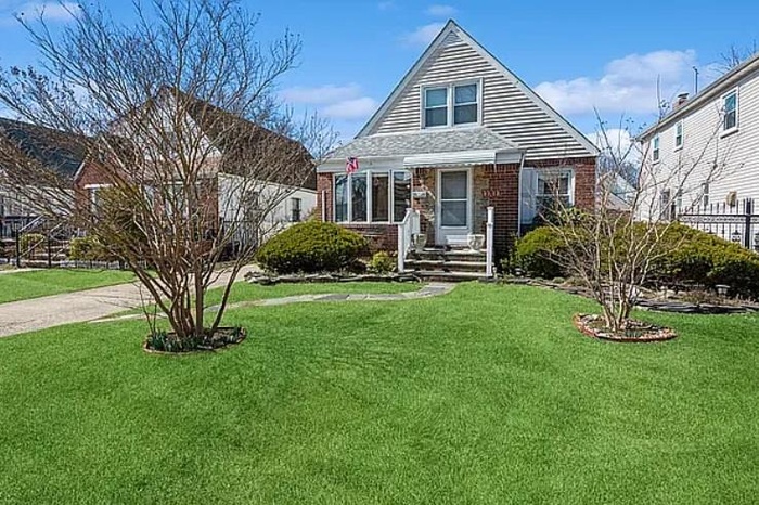 Bungalow-style house featuring brick siding