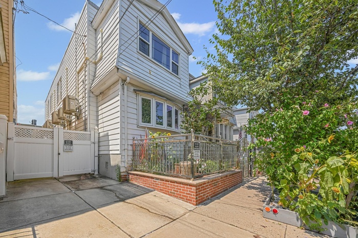 View of side of property featuring a gate