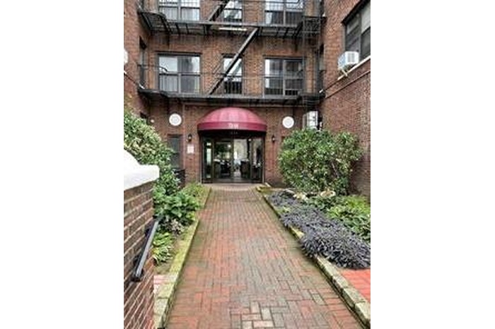 Doorway to property with brick siding