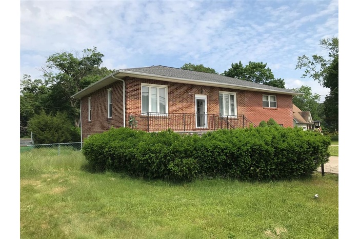 View of side of property featuring brick siding