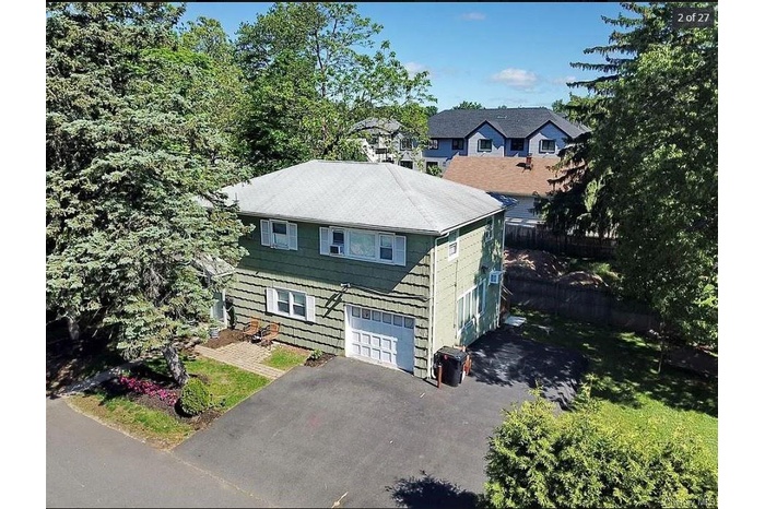 View of front of home featuring asphalt driveway and an attached garage