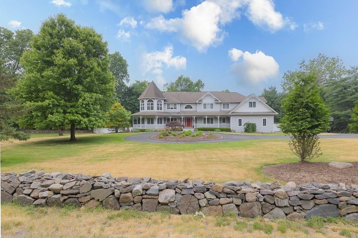View of front of house with a front yard and covered porch