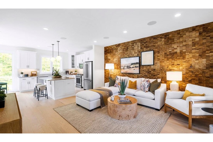 Living room featuring an accent wall, light wood-style flooring, and recessed lighting