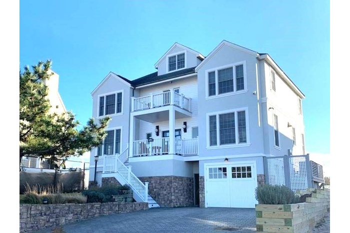 View of front of property featuring a garage and balconies