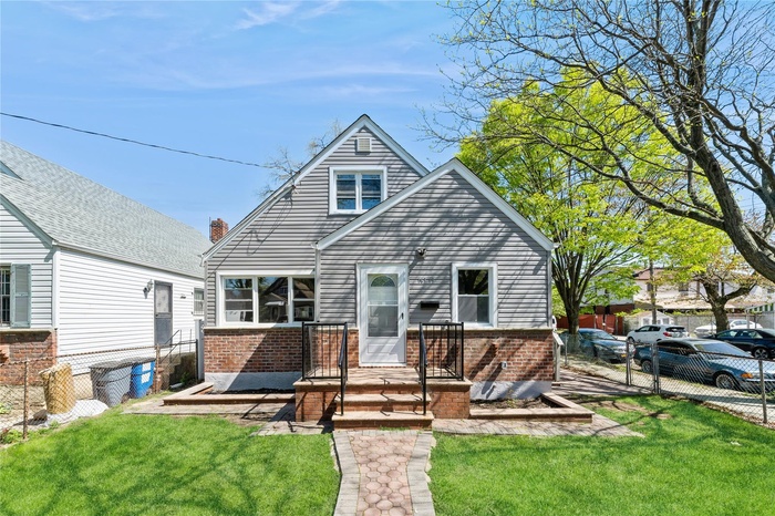 View of front of house featuring brick siding