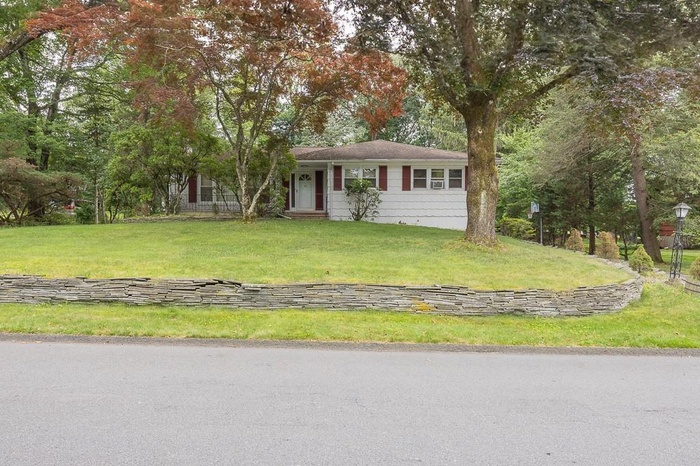 Single story home with a front lawn