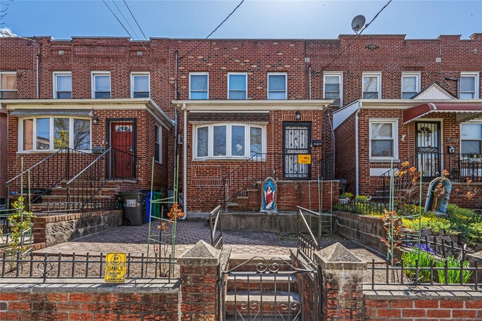 Traditional home with brick siding, a fenced front yard, and a gate