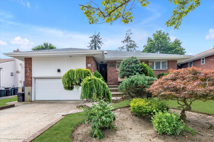Ranch-style house featuring a garage, brick siding, concrete driveway, and a shingled roof
