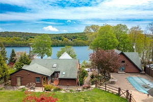 Welcome to 81 Lakeview Drive, a quintessential log cabin estate offering deeded lake rights and endless opportunities to embrace the coveted Whaley Lake lifestyle.