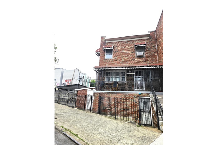 Multi-family property featuring a gate and brick construction.