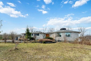 This exceptional custom designed bungalow situated on Bank Street showcases high end finishes and remarkable versatility, all set on a beautifully landscaped private acre.