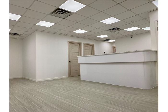 Unfurnished room with light wood-style flooring, visible vents, and baseboards