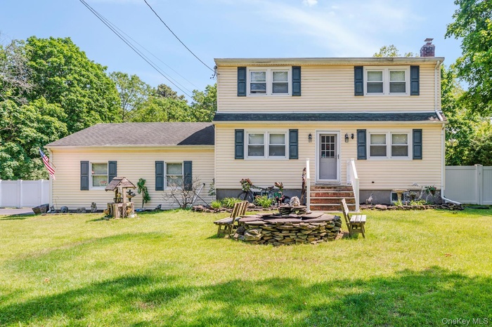View of front of property featuring a chimney and entry steps