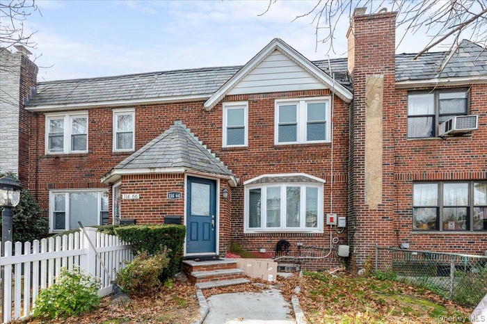 View of front of house with brick siding and a chimney