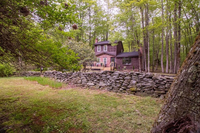 View of yard featuring a view of trees and a deck