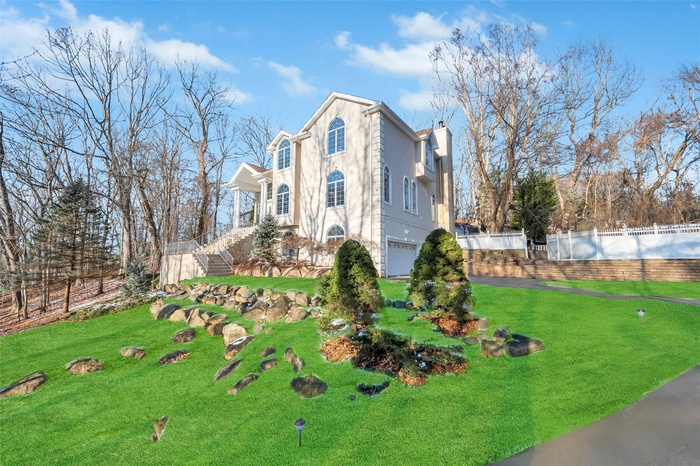 View of front of home with a garage and a front yard