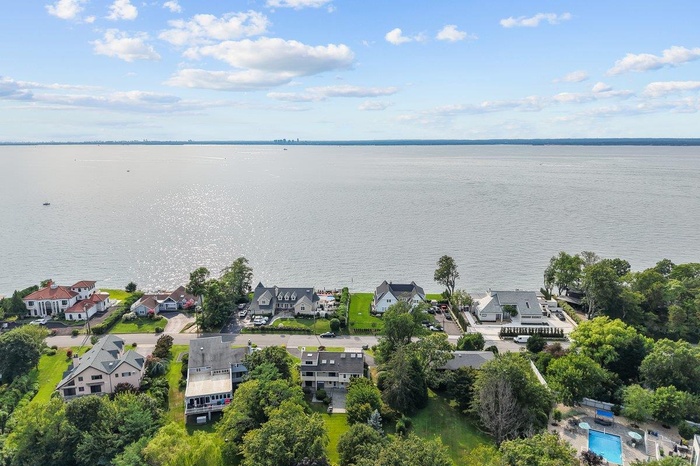 Aerial perspective of suburban area with a large body of water