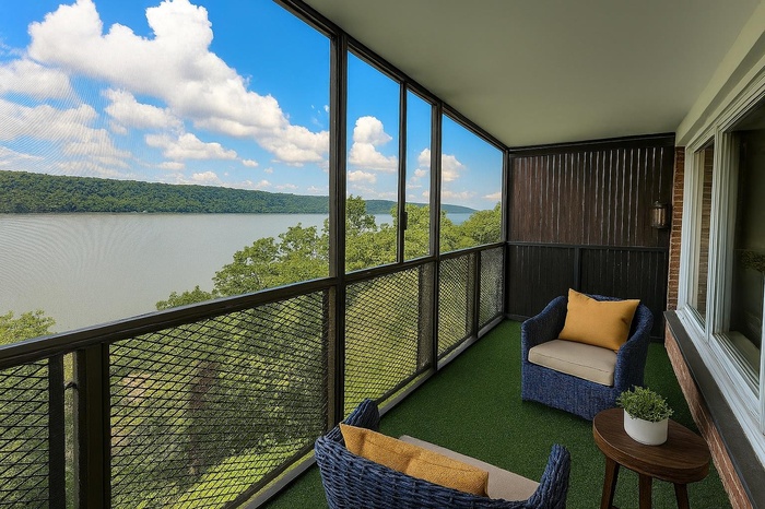 Sunroom / solarium featuring a water view