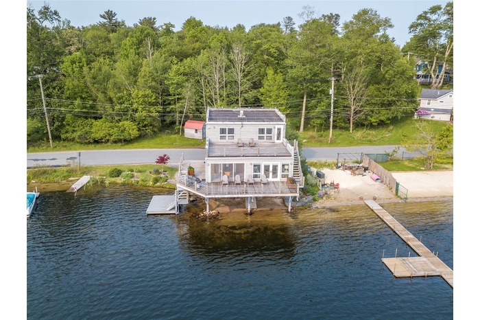 Dock area with a water view and a wooded view