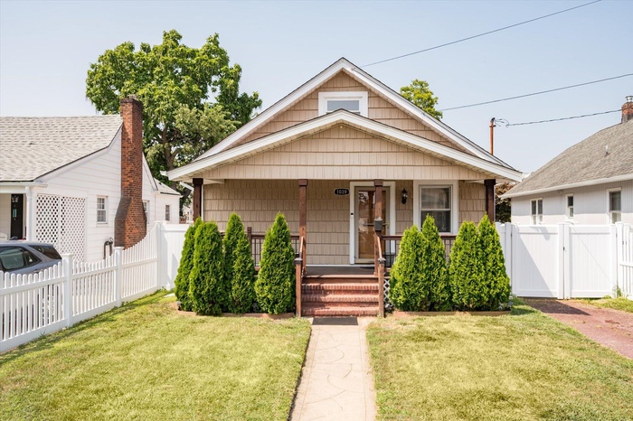 Bungalow with covered porch and a gate