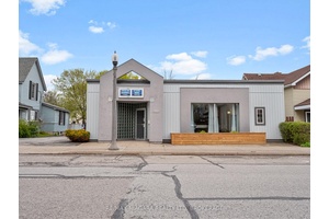 Beautiful office building with separate living quarters Front portion of the building has a large reception waiting room.