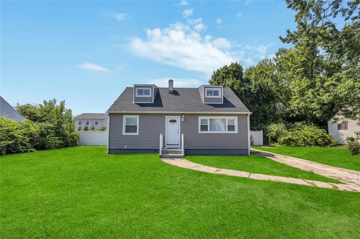 Bungalow-style house with roof with shingles and entry steps