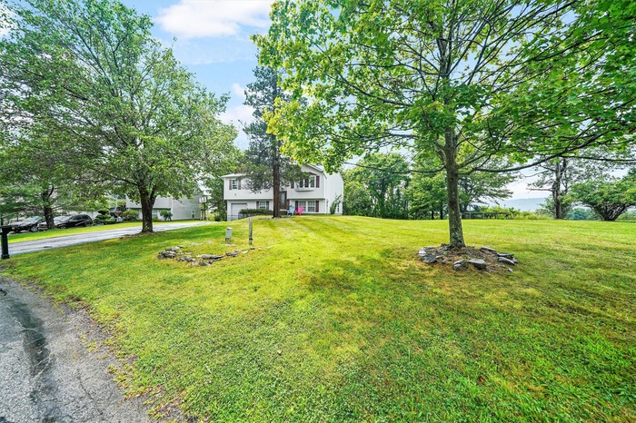 View of front of house with a front lawn and driveway