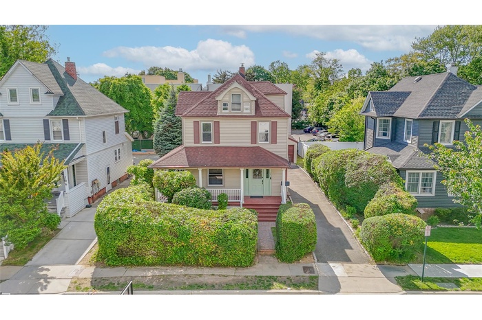 View of front of property featuring covered porch and a residential view