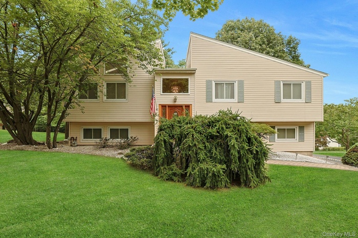 Rear view of property featuring a lawn