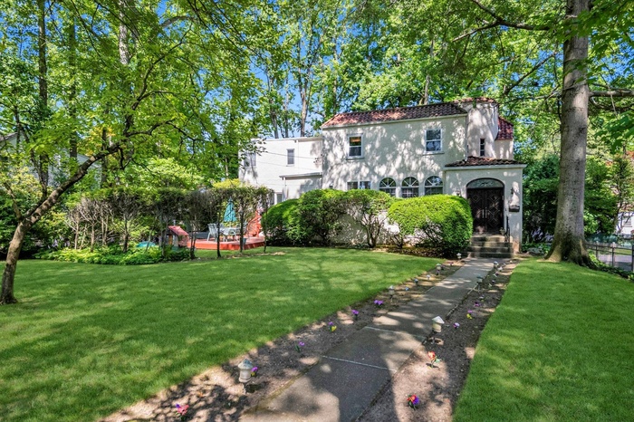 View of front of property with stucco siding and a front lawn